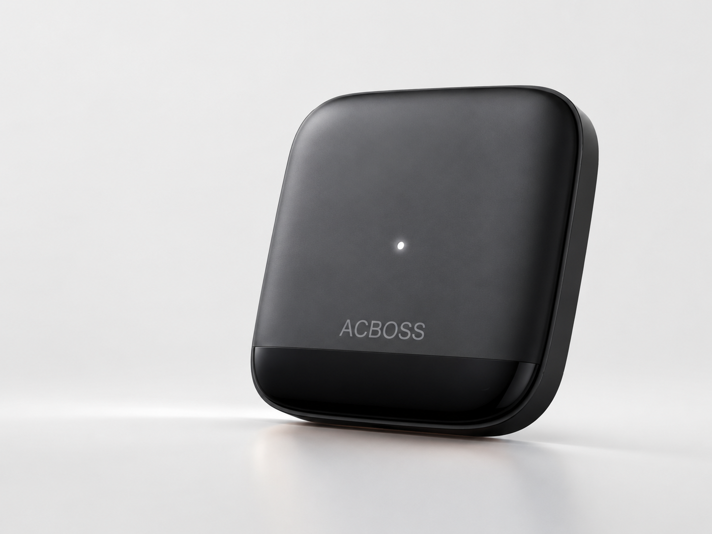 Angled close-up of the black ACBOSS controller with its status light illuminated